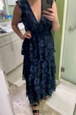 Big fan of this dress. It's lightweight but made with high-quality material. As many of the other reviews mentioned, the v-neck is very low. I sized up to a large and had it altered at the shoulders to take some of the plunge out. Fits perfectly now. The picture is after alteration. Would recommend! - Madison G.