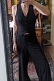 Usually, when reviews say you need to go 2-3 sizes up, I'm skeptical. With this vest, however, unless you are a AA cup or below, you need to go up. Yes, it's stretchy, but it was cut flat, meaning no bust was taken into account. I'm a 26/4 and usually a Lulus size Small. I ordered a Large (I'm a 34D) and it fits perfectly. I'm not sure a Med would have fastened without looking "pulled" in the chest. Just ignore what the sizes are called because they really don't apply to this garment. Because it's stretchy, ordering up will allow it to fasten across your bust properly without being big everywhere else. - Kimberly B.