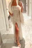 I absolutely loved wearing this dress to a NYE wedding! It's a tight fit, but flattering. Had to loosen the straps a lot when putting it on, and my husband had to help me get into it, but the thin straps held up all night-even through hours of dancing. The champagne color was perfect, the sequins didn't shed much, the slit wasn't too high, and the lace-up back was a pretty detail. I received so many compliments. 10/10. - Kelli C.