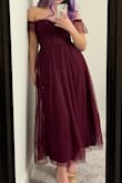 I love the dress and the design! The color leans towards purplish burgundy, and the only con is that the off-shoulder strap is too tight that it rolls up whenever my arms move (as seen in the second pic). - Tracey A.