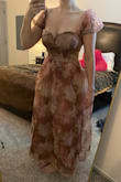 This dress would be better for someone with a small chest. The dress offers no support, and the features of it make it really tough to wear any kind of bra or use any sort of boob tape. So it basically fits like a strapless but isn't very tight around. The tie in the back is made from a material that is not made to stay in place, so it won't give you the level of support you need. Overall cute, just not flattering on/comfortable for me. - Samantha R.