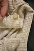Tried it on. Fit perfectly. Took off the tag. Tried to wrap the thread loop around the button in the back. Button immediately came off. First time wearing it- [come on]! - Nikki N.