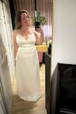 I really like the dress and ended up choosing it! It fits very well and I like that you can tighten the waist with the sash. The lining is also nice. The pearls are pretty but do move around a bit, so it won't always look like a straight line. - Alethea R.