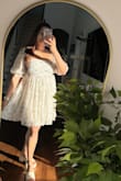 This dress is true to size, and the fabric is very light and flowy. Can definitely wear it in the summer/spring. The colors are really pretty. and I didn't have to wear a bra with it. It's not short- perfect length actually. - Roopal K.
