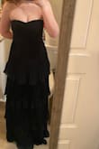 I sized down and ordered an XS because I was worried about pulling up the dress all night. It fits my bust perfectly and makes them look so good. It's not too long for a petite person (wearing heels). I could be hemmed a bit but it looks stunning! - Kate Z.