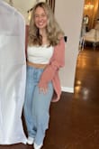 Super cute tiny cropped tank. Love the ribbon sleeve details. It was a little on the small side so maybe size up if you're not sure! Overall love this tank it's super fun! - Brianna G.