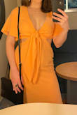 The quality of the fabric wasn't bad at all. I was originally going to wear without a bra and just some pasties, which would have been fine, but I have a small chest so I decided to fill up the extra space. I just had to tie my bra into the knot so it wasn't visible. The small wasn't tight on me but it definitely didn't hang loose. I wore this to a cruise wedding and I think it was perfect for the occasion. Elegant with the length and some heels to match, but playful. I recommend it, especially for any kind of tropical/daytime wedding! - Jaymi C.