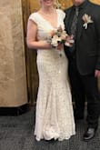 This was truly beautiful. My original order had a sewing error in the skirt underneath, but I was able to exchange the dress. The new one got shipped super quickly and arrived in time for my wedding. The dress fit great to size. No alterations needed. It was comfortable. No complaints. Received so many compliments - Anne L.