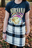 The skirt is a tad high-waisted and maybe a little short, which is why my daughter wore tights with this skirt. Paired it with a pair of combat boots and a band tee for the perfect "grunge" look! - Stacy L.