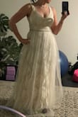 It did not flatter my figure at all. It fits rather well though; chest looks excellent. I almost settled with this one until my sister took me out to try on wedding dresses, and I ended up finding the one. I was not really a fan of the tulle on the outside either, felt it took away from the design. Was considering removing the outer layer before I returned it. Something to consider. - Nichole S.