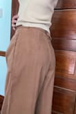 It's made of a type of thin material, but it looks nice. I love the belt because you can easily adjust it to your waist. Perfect length for me so I don't have to wear high heels. - Karla C.
