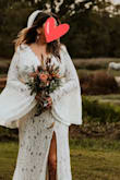 This dress is gorgeous and was perfect for our elopement. I wanted it to be simple, and elegant with a boho vibe. There is a seam around the waist. I just added a simple thin leather belt with a feather. I went barefoot and it was definitely long enough. I could have worn a low heel and still had enough length. It has a nice train in the back. I wish I had enough time to sew the liner to the slit opening but it wasn't that noticeable. I absolutely love this dress! - Tracey S.