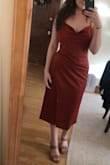 I feel so good in this dress! The ruching skims over my stomach and highlights my hips. I typically wear a size 6 and a S fits nicely. Even though it hits below the knee, it still feels sexy because of the fit. - Isabelle E.