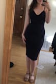 This dress definitely doesn't leave a lot of room. It sucks everything in. I feel like it flattens my chest. I wear a size 6 and typically order S or M depending on the fit, but reviews were so mixed here! I'd feel more comfortable in a M. I do like the combo of length and classic color with the sexy fit. - Isabelle E.