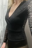 Cross over part in the front stays centered; it's nice and snug in the front- no need to worry about accidentally flashing someone from movement. I don't wear a bra with it because of the pretty back! Size Sm. - Sarah S.