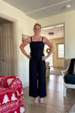 This is such a flattering jumpsuit! It fits perfectly! It is a little longer on me than the picture. I'm only 5'3 but with a pair of wedges, it's perfect! Can't wait to wear it at my daughter's college graduation in May. The only issue is the zipper is tough to zip up myself. It gets stuck at my mid-back.  Will need to have help or maybe will exchange for another to see if the zipper is better! But I definitely recommend it! - Amy S.