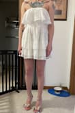 High-quality fabric, and fits well but is kind of tight- I can't take a deep breath. Feels VERY short- I'm not super tall, but it feels like my butt would show if I bent over. The ruffles help with that, but if there was any wind I think people would get a show. I held on to it for a bit after ordering because I was on the fence about it, but sadly I will be returning. - Molly S.
