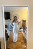 I bought and wore this for my wedding rehearsal and rehearsal dinner. It fit perfectly, I only had to get it hemmed. It was so comfortable, flattering, and beautiful. I ordered a size small. It's pretty stretchy, so If you're on the fence or in between sizes I would say it's safe to size down. - Megan L.