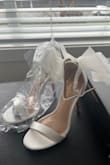 I'm typically a size 5.5. Most of the reviews said they run large so I ordered a 5. Way too small, the toe strap runs very small so I would recommend sizing up. I have re-ordered these in a size 6. Fingers crossed they fit. The bow is an interesting material; it's not tulle but more of a plastic. - Summer L.