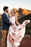 This dress was stunning for my engagement shoot. The wrap-around style with the ties was a little confusing at first, but it's actually nice for making the dress fit. The shoulder straps are actually adjustable as well. The dress is well lined and not see through at all. You can "work" the slit for pictures, but it's not always visible; you have to pull the dress to get a little leg showing. Like others have warned, the button that is supposed to hold the top bust triangles together pretty much fell off the first time I tried the dress on (minus a star for that). After getting in the dress, I used a safety pin on the inside to hold the top triangles together; it was fine. The length for me was perfect with heels but would have dragged if I wore flats. The top felt a little big, but I don't think it looked or felt big enough to warrant me sizing down. - Brindley F.