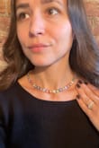 I bought this just in time for spring - it sits beautifully just above my collarbone (no flipping or turning as the previous review suggested).  Such a pretty, substantial piece! - Amanda K.