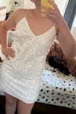 Fits true to size and the strappy back is very cute. Comfortable fit and not too short where it would be riding up all night. I like the dress and would buy it again! - Riley G.