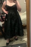 It looks darker in the picture, but this dress has pretty green highlights when the light hits it. It provided support and helped its shape really well to give it some size and volume. - Devyn C.