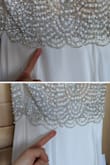 Initially, I purchased this dress in numerical sizes for my wedding, opting for a size 2, and it served me well. All the jewels and gems were in place. I bought a second one to alter it into a hi-low party/celebratory dress, but I noticed some changes. Firstly, the sizing seems slightly smaller; I had to settle for an XS (I usually wear 2 at Lulu's) but fortunately, it still fits. However, the most concerning issue is the decline in quality. There are noticeable missing gems on the bottom part of the dress's top section, which is disappointing. I plan to have it altered and request that they fix the issue, given my limited time. It's upsetting to see the quality diminish since my initial purchase. Needless to say, the dress is beautiful, but please keep in mind that the dress becomes more fragile than my first. - Yearim Y.