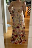 This dress is gorgeous - the 3d flowers are beautiful and vibrant. I am a bit worried as there were quite a few loose threads I noted especially on the blue flowers and how this will hold up over time... I love the tie straps (though agree these could be a bit more sturdy given the weight of the dress). I'm 5'0" and am wearing 3.5" heels and will likely need to hem it an inch or two, but if I lifted up the hem it would certainly be do-able if I was short on time. The flowers will probably need an iron to sit flat rather than curl up a bit but that's more noticeable from the wearer's perspective (looking down the dress) than everybody else's perspective. Overall, a beautiful piece that looks perfect for a wedding. Since I'm short I'll probably need it hemmed so that adds to the overall cost as well. - Jade W.
