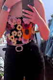 This top is exactly like the pictures. It was super cute with flower detailing along the front. Great quality and fit amazingly! Would recommend! - Macy B.