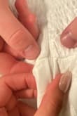 I was so excited to try on this dress, but the zipper would not go up even when I took the dress out. Later on, we realized it was broken because it kept getting stuck on that one part. We couldn't get it to go all the way up. - Noemi G.
