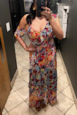 This dress is so pretty in person. The only issue I had was the strap that held the off the shoulder ruffle up was a bit too long and not adjustable, this made it slip often which was problematic as I'm on the busty side. The colors are beautiful and I got compliments all night. There's no stretch and it's true to size. - Claudia T.