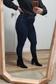 The boot size itself was true to size, but if your calves are on the thicker side (mine are slightly) they will fit tight. In my case they fit to the point they were tight but not uncomfortable. I think that's why it doesn't end up having that western look as much because calve area of the boot is slimmer than the photo. Beside that I was still able to wear over a skinny Jean! The boots are still very sexy!!! Right height too! Not too short or too tall and super comfortable to walk in all day long! If you're looking for these kind of boots, these are your girls! - Debora A.