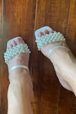 I purchased these sandals for my wedding weekend. When I first got it the sandals had 2 blue markers on the side of the sandals where the pearls end. The satin fabric is not neatly wrapped around the sandal. It fits comfortably the style is pretty. Of course, it's made in China but I still like them. Thank you, Lulus! - Ernestine D.