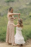 I purchased this dress for mommy and me photos with my daughters, and I'm so happy I did! It was perfect for our outdoor shoot. Fits true to size, and the back detail is so adorable and makes the dress so flexible with sizing. Would highly recommend!! - Haley C.