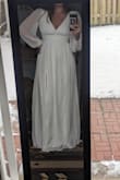 This dress is very beautiful. A bit tight around the ribcage/bust, however based on other reviews I somewhat expected that. The material seems really lovely and feels great. I adore the sleeves and the leg slit. The length is great for me but I am 5'10-11. I'm definitely leaning towards this dress for my elopement! - Shay F.