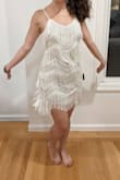 The PERFECT bachelorette party dress! The texture is so unique, it has some sparkle, and the fringe has great movement! It's short but the lining still covers your booty and the fringe offers extra length. I love this dress, looking for other opportunities to wear it! - Beatriz K.
