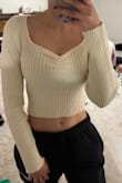 Did not look cropped from the picture, so it's shorter than what I expected. The material feels cheap and not super comfortable. Overall look is okay but not of great quality. - Arlie M.