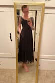 I don't know why no one has mentioned that this dress has pockets!!! I'm obsessed. The black is giving all the witchy vibes I was looking for. Yes- this dress definitely runs a tad large. I'm usually a borderline small, closer to medium. Reading the reviews, I ordered a small; it's still a little large on the chest (I had to put on a push-up bra to fit into it but I'm only a 32b). It's also a lot longer than I expected but I've also noticed that with previous dresses. I also love that it has the corset bar on the sides to help the top seem more elegant and put together. - Gracie F.