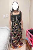 Upon receipt of this dress, I immediately noticed various loose threads in the embroidery. One flower was also cut off at the seam under the bust in the middle of the bodice. Considering the 3D flowers are supposed to be a show stopper, I feel like your eyes are drawn to this mistake in design. While the double-lined material of the dress was comfortable, I had issue with the thin mesh tie straps. They seemed too delicate to bear the weight of the dress. I would have preferred sturdier straps hidden under the romantic fluttery ribbons. Since the dress was too long (normal for me), I would have had to alter those flimsy straps. I wouldn't remove any of the beautiful flowers from the bottom, especially the orange one that pops against the other colors. But I don't want to deal with the straps snapping off, so I have initiated a return. The dress still looked pretty from afar; my photos were just taken quickly in unflattering indoor lighting. - Alice Y.