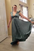 Love the fit of the dress and the back is fun! The fabric is very well and thicker them satin with the under layer. Great movement twirling in the dress as well.  With the back being lace up, the top is adjustable for comfort. Love the color and pleats make the whole dress. - Shelly S.