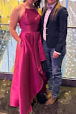 I wore this dress to the "Boots & Ballgowns Charity Gala, and it was absolutely stunning. It feels like high-quality fabric, elegant and sophisticated. Despite arriving folded in a bag, a quick steam before the event restored its pristine appearance. The vibrant magenta hue complemented my complexion perfectly, and the high-low design added a touch of modern flair. Throughout the evening, I felt incredibly pretty and received numerous compliments on the dress. Its impeccable quality and striking appearance made it a standout choice for the gala, and I couldn't have been more delighted with my selection. - Kara W.