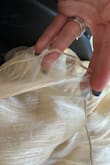 This dress is beautiful! I bought it for work photos, and everyone loved it! However, I wore it a second time, and these little [pieces] are popping up out of nowhere! I've worn the dress for photos and to church, so no strenuous activity is being done in it. Very sad considering the price - Hannah C.