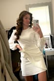 I love this dress! The material is nice; however, it is NOT stretchy. Make sure you get a size that you can comfortably move/sit in. I like that you can tie the knot in different styles. I was worried it may be too short and/or ride up while walking, but it doesn't do either. - Jenna K.