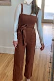 This could be SO cute. Unfortunately the sizing is super weird. I have an athletic body type so my waist is not "hourglass," but my measurements (and the fit finder) indicated I should get a small. I read reviews that said it ran small so I ordered the small and medium. The small fit everywhere EXCEPT my waist when I breathed deeply - whoever designed this didn't imagine people would need to breathe in it. The corduroy waistband has absolutely NO give at all. So even though it fit when I had it on at rest, if I took a deep breath it dug into my stomach. Not smart design. But then, I tried on the medium and I was SWIMMING in it. The difference between small and medium was honestly staggering. I thought about getting the medium tailored but the corduroy was already snagged/messed up in some places when it arrived so I did not want to dump money into a low-quality product. The photo where it looks cute is the small and the photo where it looks incredibly baggy is the medium. - Erin D.
