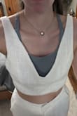 I ordered this outfit for my bachelorette party and my rehearsal dinner along with the pants to match. I have an athletic body type with minimal curves. I originally ordered a size small and it was a little too tight around my ribs, too big in the bust, and perfect length. I had a long debate with myself if I should exchange it for a medium. I ultimately wanted to comfortably breathe at my rehearsal dinner so I exchanged it for a size medium. The size medium fit perfectly in the rib cage area, but now it's extremely big in the bust. The material is worth the money! It's comfortable, soft, and seems durable. I love the quality, but disappointed in the fit. I am going to stick with the size medium and pay extra for alterations. I think if you have my waist size with some curves then this outfit should fit you perfectly. The pictures below are in a size medium. - Deanna R.