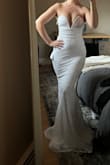 The dress was super comfortable and the train was a great length! The dress really made me feel like I had some shape when often times I feel like I don't have much of a figure. It felt very supportive for being strapless and low cut. I really wanted this to be the one! I couldn't quite figure out the wire in the top. If I pulled the dress up more, the wire would bulge out and not sit flush. if I pulled it lower it sat better on my body, but then I felt like my nipples were just barely getting covered. I wasn't able to get the amount of coverage I wanted on top without having to constantly hold the wire down on my body. Ultimately, I'm choosing another dress because I feel as though I would be too fixated on my chest area throughout the day. - Katelyn H.