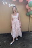 The dress is beautiful but it runs really big. I am a true medium, but had to return it and order a small. It was still too big, but I had to wear it anyway. I will have to have the dress altered for future use. The dress is beautiful and the fabric responds really well to steam to get the wrinkles out. - Rachel D.