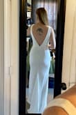 The dress fits well. Will need to get it hemmed at the bottom and will need to wear shapewear day of because it's tight. Not super thick fabric but also not paper thin. - Allissa R.