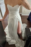 Love this dress! Fit like a glove in the bust. I carry a lot of my weight in my hips and legs, so the 4 fit me perfectly snug on top and I won't need alterations in the top. It also holds up really well and doesn't slip down with lots of movement. The stitching at the back under the top portion of the dress bubbles a bit (see photo). I'm hoping I can have the layers unstitched so that the fabric lays flat and looks a little more polished.
Like others said, the slit is super high up so I'll have it closed a little. 
The fabric is super high quality - very delicate though so be careful with it. - Olivia M.